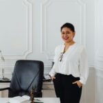 Confident businesswoman smiling in elegant office setting, perfect for corporate themes.